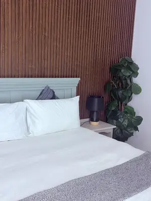 a bedroom with a white bed and a plant at 43 Home Reyno ridge in Witbank