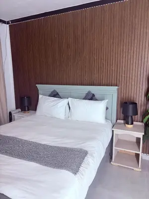 a bedroom with a large bed with two night stands at 43 Home Reyno ridge in Witbank