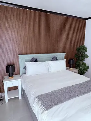 a bedroom with a white bed with two night stands at 43 Home Reyno ridge in Witbank