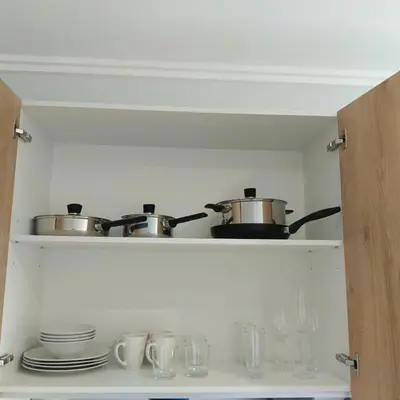 a kitchen with two pots and pans on a shelf at Sunrise Waterfall at ELLIPSE in Midrand