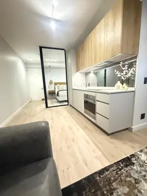 a living room with a couch and a mirror at Sunrise Waterfall at ELLIPSE in Midrand
