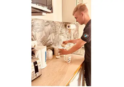 a man in a kitchen preparing a cup of coffee at Cottage of Grace in Benoni