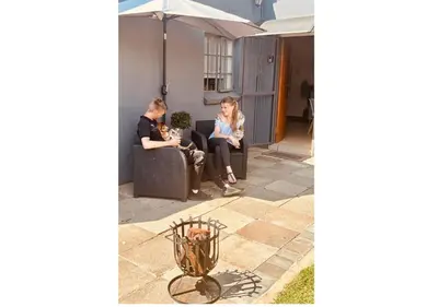 two people sitting on couches in a patio at Cottage of Grace in Benoni