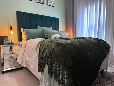 a bedroom with a large bed and a window at Indulge in Elegance & Comfort in Midrand