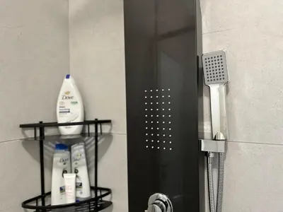 a bathroom with two shelves with toothbrushes and a mirror at Indulge in Elegance & Comfort in Midrand