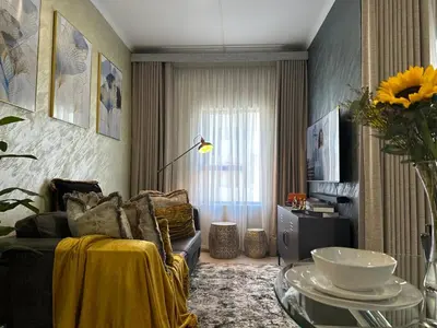 a living room with a couch and a table at Indulge in Elegance & Comfort in Midrand