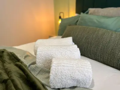 two towels are sitting on top of a bed at Indulge in Elegance & Comfort in Midrand