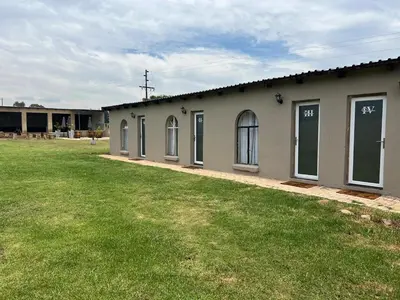 a building with windows and a grass yard at The Vibe Venue in Pretoria
