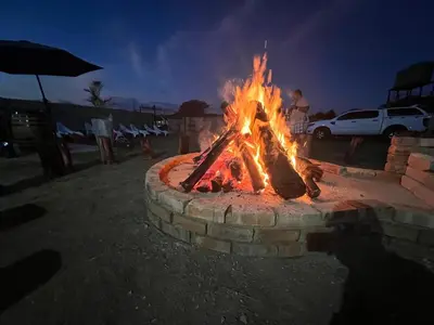 a fire pit in a parking lot at night at The Vibe Venue in Pretoria