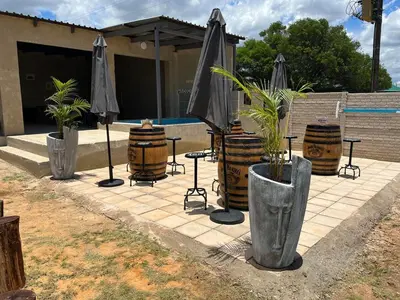 a group of umbrellas and potted plants on a patio at The Vibe Venue in Pretoria