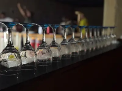 a row of wine glasses lined up on a table at The Vibe Venue in Pretoria