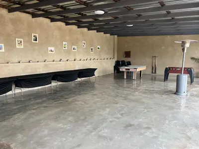a room with a ping pong table and chairs at The Vibe Venue in Pretoria