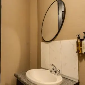 a bathroom with a sink and a mirror on the wall at 10 Kooralboom Self Catering Apartments in Nelspruit