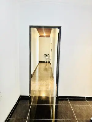 a hallway with a door open to a room with a table at BTV Villa in Hazyview