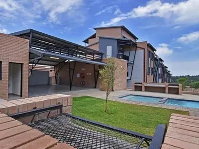 a house with a swimming pool in the yard at Waterfall Views in Midrand