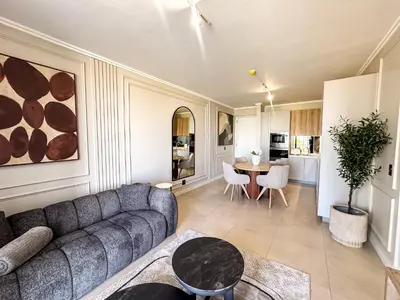 a living room with a couch and a table at Luxe 4608 Ellipse Waterfall in Midrand