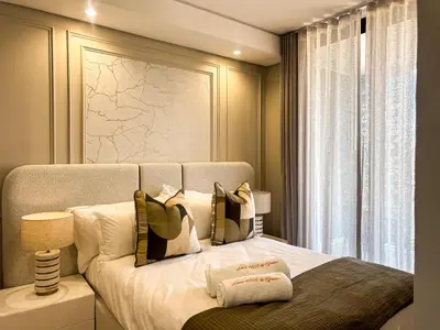 a bedroom with a bed with pillows and a window at Luxe 4608 Ellipse Waterfall in Midrand