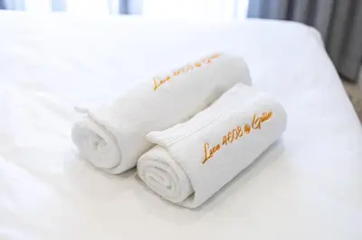 a pair of towels sitting on a bed at Luxe 4608 Ellipse Waterfall in Midrand