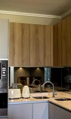 a kitchen with two sinks and wooden cabinets at Luxe 4608 Ellipse Waterfall in Midrand