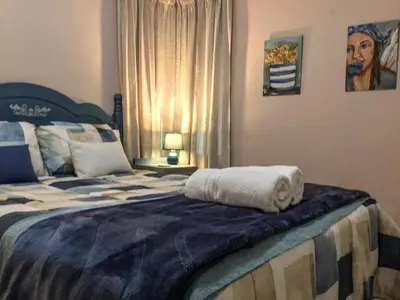a bedroom with a large bed with towels on it at Corner View Accommodation in Kaapsehoop