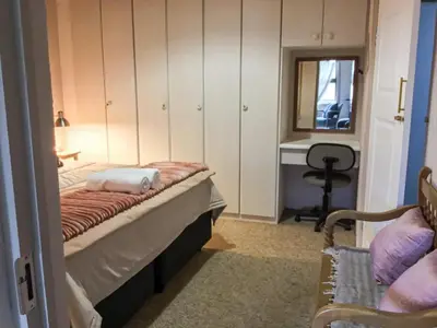 a bedroom with a bed and a desk and a mirror at Corner View Accommodation in Kaapsehoop
