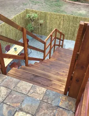 a wooden bench and a table on a patio at Corner View Accommodation in Kaapsehoop