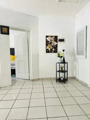 a room with white walls and a white tile floor at Hlatsi Bushview Apartments & Safaris in Hazyview