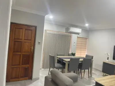 a dining room with a table and chairs at Omega 8 in Polokwane