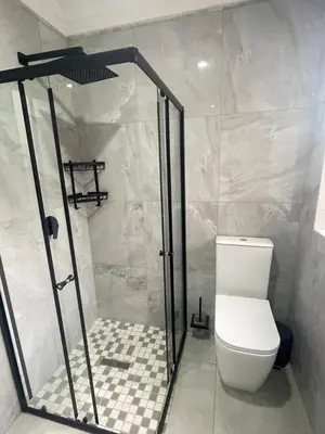 a bathroom with a shower and a toilet at Omega 8 in Polokwane