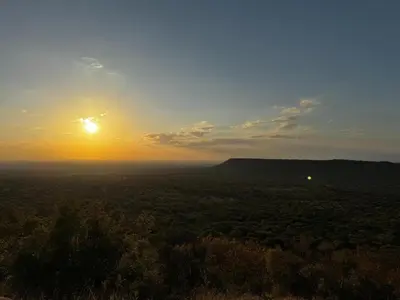 a view of the sunset from the top of a hill at Sundara Safaris