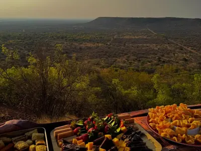a tray of different types of food on a table at Sundara Safaris