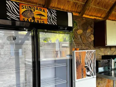 a refrigerator with a sign on top of it at Sundara Safaris