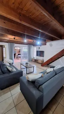 a large living room with two couches and a table at Secure house in complex near OR Thambo airport in Johannesburg