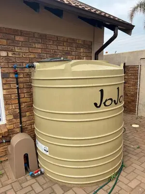 a largeige barrel sitting outside of a house at Secure house in complex near OR Thambo airport in Johannesburg