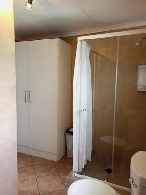 a bathroom with a shower and a toilet at The Tranquility Suite & Spa in Kempton Park