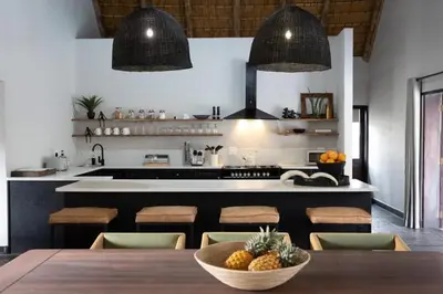 a kitchen with a table with a bowl of fruit on it at Landrift Villa in Phalaborwa