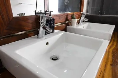 a bathroom with a white sink and two sinks at Landrift Villa in Phalaborwa