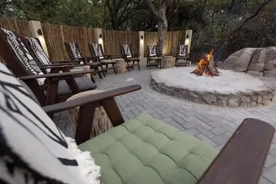 a fire pit with several chairs and a fire ring at Landrift Villa in Phalaborwa
