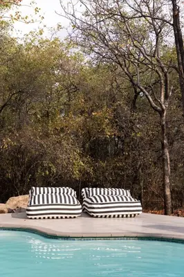 two pillows sitting next to a swimming pool at Landrift Villa in Phalaborwa