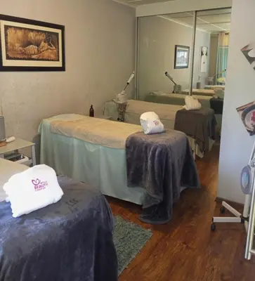 a hospital room with two beds and a mirror at The Goshen Residence & Spa in Kempton Park
