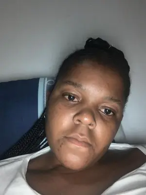 a woman is laying on a bed with at Rejoice Thuli in Mabopane