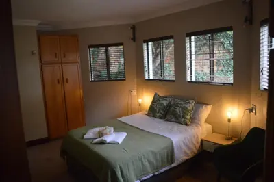 a bedroom with a bed with a stuffed animal on it at Guesthouse Charis in Pretoria