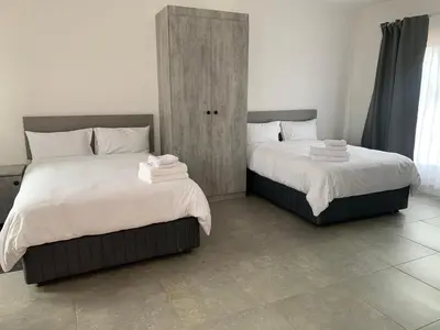 two beds sitting next to each other in a bedroom at Florencepalms resort & Spa in Marble Hall