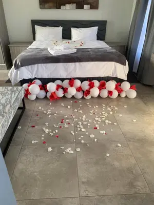 a bed with a bunch of flowers on the floor at Florencepalms resort & Spa in Marble Hall