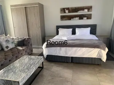 a bed in a room with a couch and a bed sidx sidx sidx at Florencepalms resort & Spa in Marble Hall