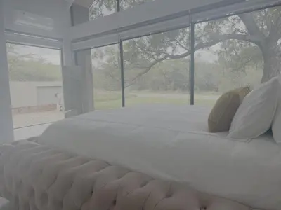 a large white bed in a room with a window at Kambula Villa 374 Euphoria in Naboomspruit