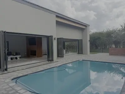 a swimming pool in front of a house at Kambula Villa 374 Euphoria in Naboomspruit