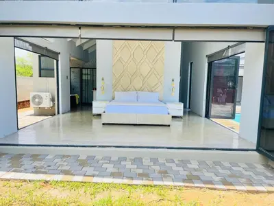 a bedroom with a bed in the middle of a building at Kambula Villa 374 Euphoria in Naboomspruit