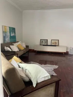 a living room with two couches and a table at Lani Accommodation in Pretoria