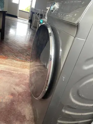 a washing machine with its door open in a room at Lani Accommodation in Pretoria